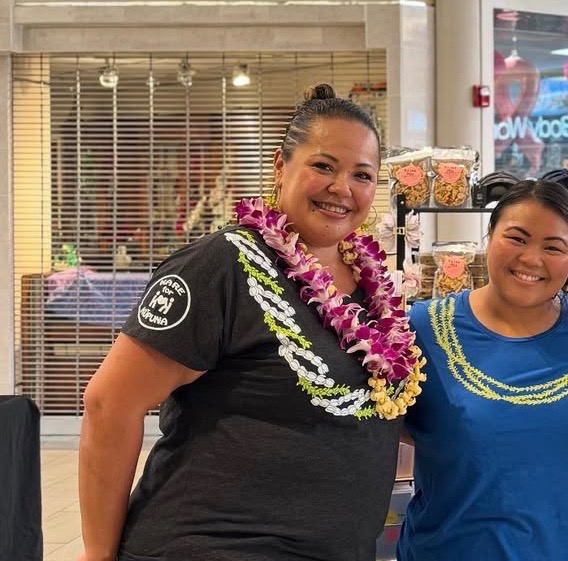 Trina wearing lei with a client at a local Hawaii community event